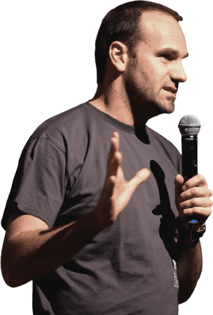 Mark Shuttleworth: A young man holding a microphone close to his mouth carrying out a presentation