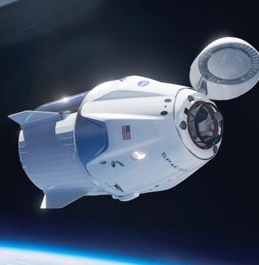 A white space capsule that looks like a shorter and more fat rocket in space near the atmosphere of Earth